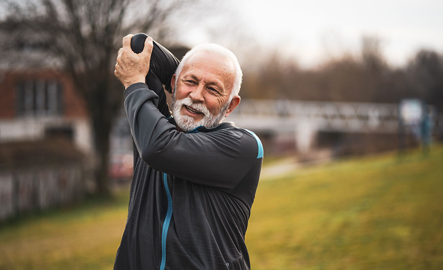 Senior man stretching his shoulder