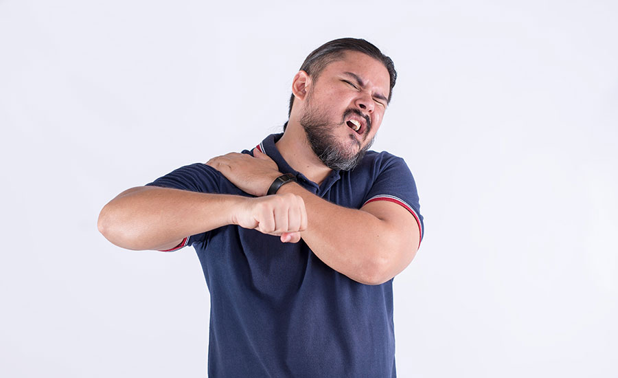 Man holding his shoulder in pain